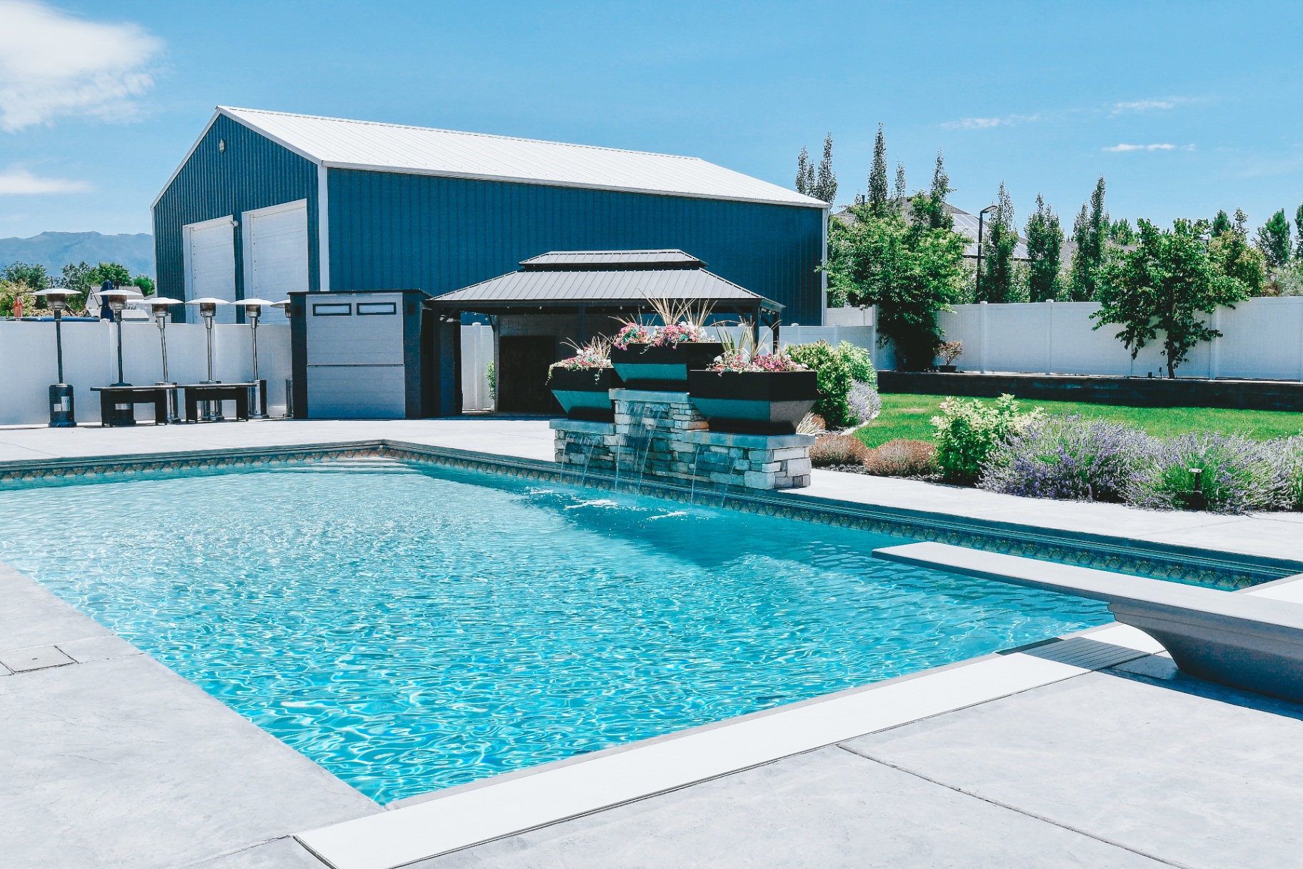 West Haven Utah Pool with Covered Pavilion — Barr Pool Builders Backyard vinyl swimming pool with covered pavilion, outdoor heaters and shop in West Haven, Utah custom built by Barr Pool Builders